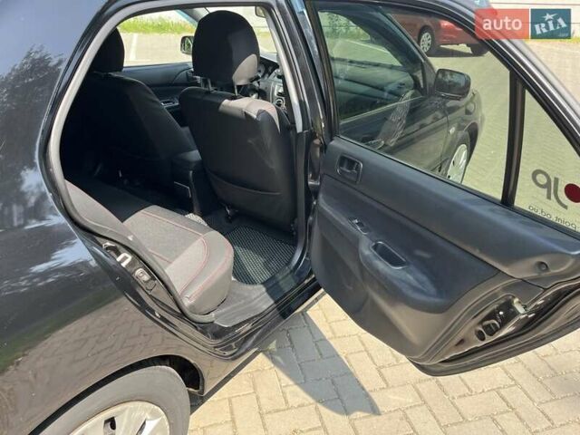 Чорний Міцубісі Lancer, об'ємом двигуна 1.6 л та пробігом 296 тис. км за 4200 $, фото 42 на Automoto.ua