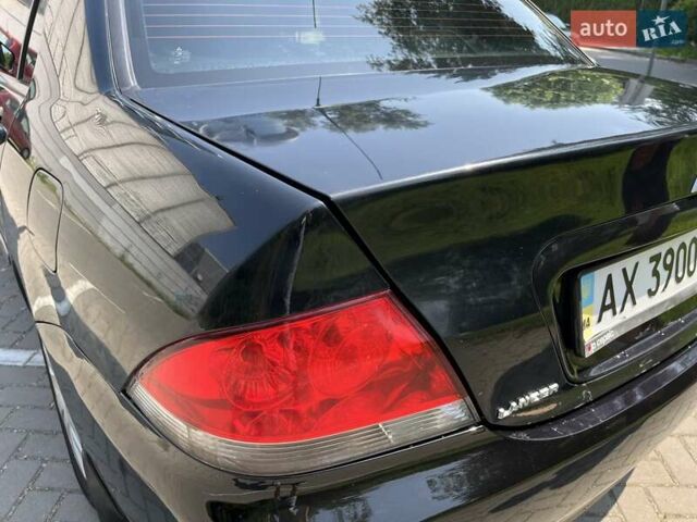 Чорний Міцубісі Lancer, об'ємом двигуна 1.6 л та пробігом 296 тис. км за 4200 $, фото 22 на Automoto.ua