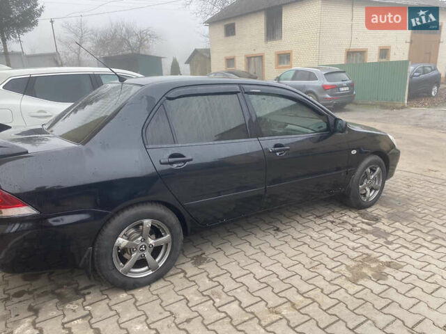 Черный Мицубиси Лансер, объемом двигателя 1.58 л и пробегом 211 тыс. км за 6333 $, фото 27 на Automoto.ua