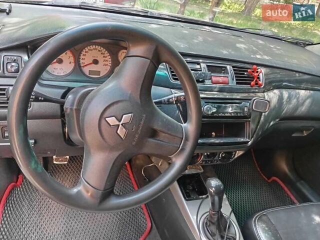 Черный Мицубиси Лансер, объемом двигателя 1.6 л и пробегом 445 тыс. км за 2999 $, фото 1 на Automoto.ua