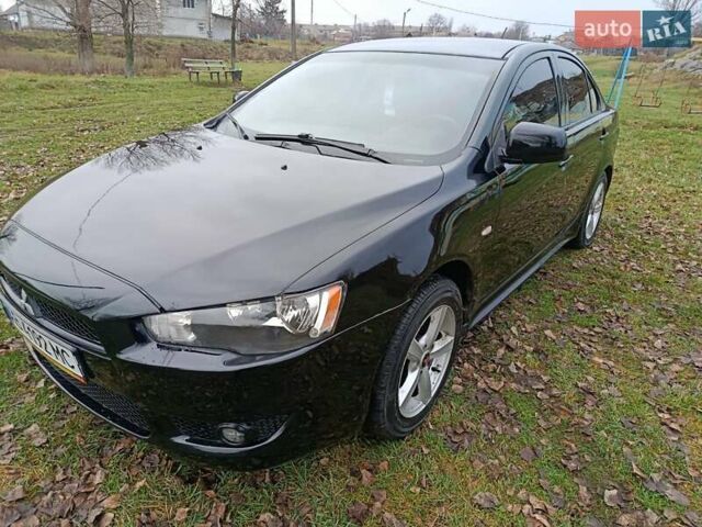 Черный Мицубиси Лансер, объемом двигателя 2 л и пробегом 200 тыс. км за 5100 $, фото 1 на Automoto.ua