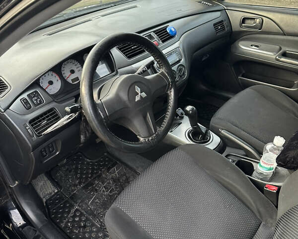 Черный Мицубиси Лансер, объемом двигателя 1.58 л и пробегом 312 тыс. км за 4900 $, фото 4 на Automoto.ua