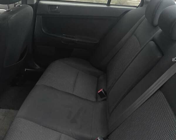 Черный Мицубиси Лансер, объемом двигателя 2 л и пробегом 192 тыс. км за 6350 $, фото 13 на Automoto.ua