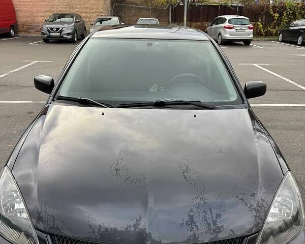 Чорний Міцубісі Lancer, об'ємом двигуна 1.6 л та пробігом 245 тис. км за 4500 $, фото 1 на Automoto.ua
