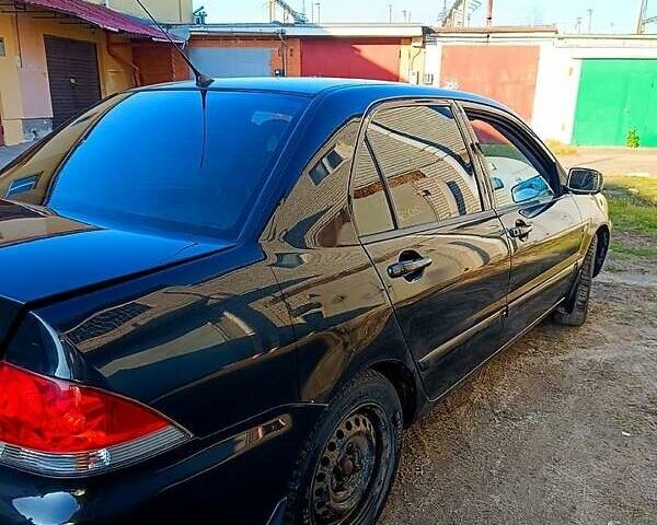 Черный Мицубиси Лансер, объемом двигателя 1.6 л и пробегом 230 тыс. км за 4700 $, фото 4 на Automoto.ua