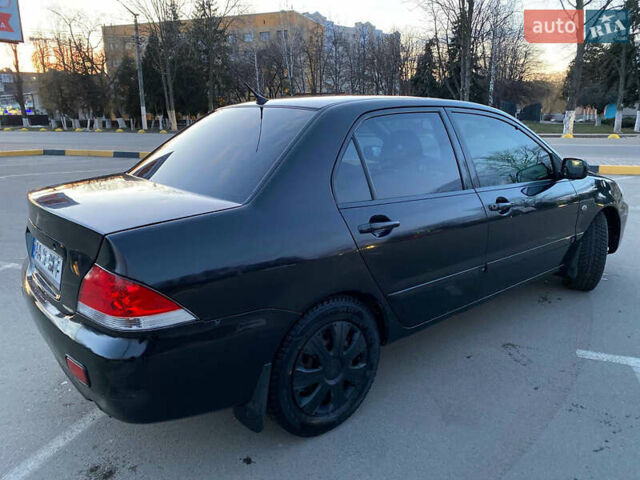 Чорний Міцубісі Lancer, об'ємом двигуна 1.58 л та пробігом 327 тис. км за 4000 $, фото 4 на Automoto.ua