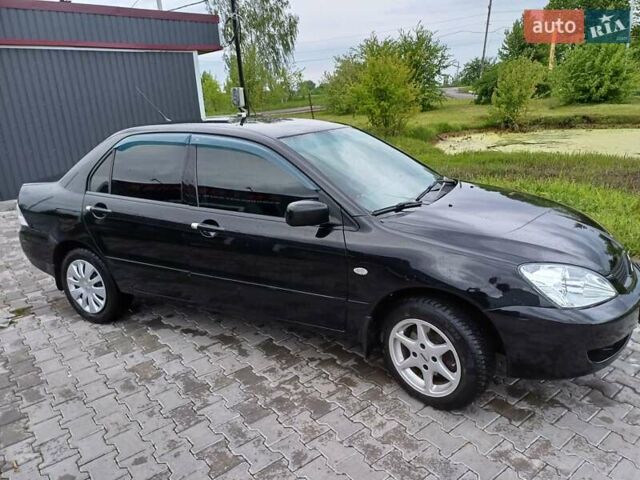 Чорний Міцубісі Lancer, об'ємом двигуна 1.6 л та пробігом 200 тис. км за 4900 $, фото 13 на Automoto.ua