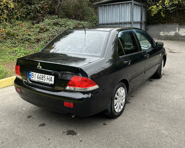 Чорний Міцубісі Lancer, об'ємом двигуна 1.58 л та пробігом 192 тис. км за 4500 $, фото 2 на Automoto.ua