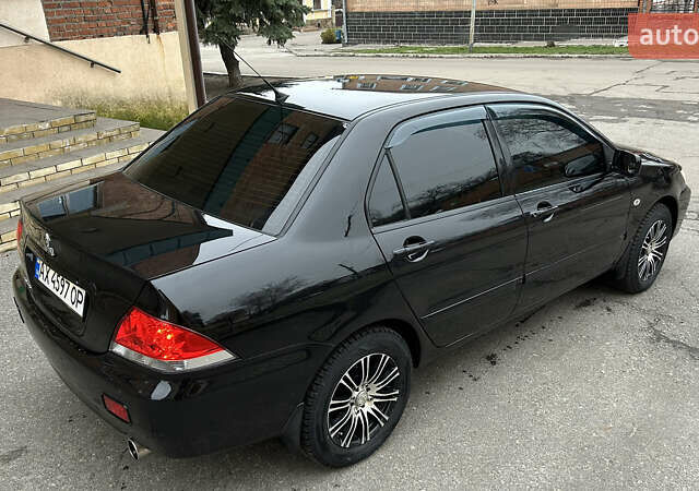 Чорний Міцубісі Lancer, об'ємом двигуна 1.58 л та пробігом 167 тис. км за 4800 $, фото 3 на Automoto.ua