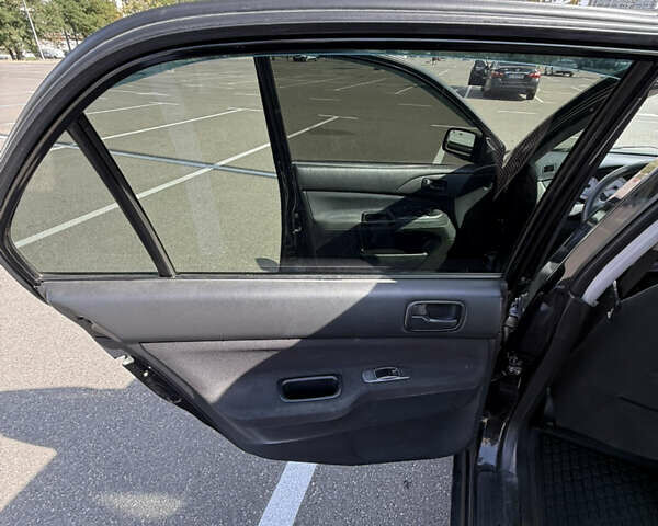 Черный Мицубиси Лансер, объемом двигателя 1.6 л и пробегом 321 тыс. км за 5000 $, фото 31 на Automoto.ua