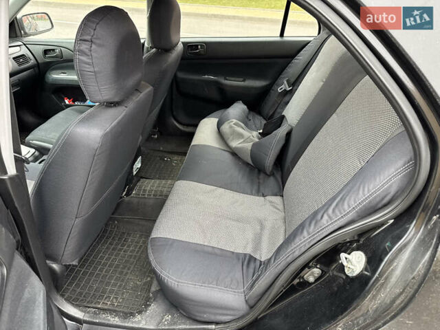 Чорний Міцубісі Lancer, об'ємом двигуна 1.58 л та пробігом 388 тис. км за 2300 $, фото 12 на Automoto.ua