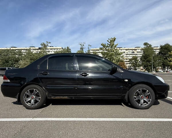 Черный Мицубиси Лансер, объемом двигателя 1.6 л и пробегом 321 тыс. км за 5000 $, фото 1 на Automoto.ua