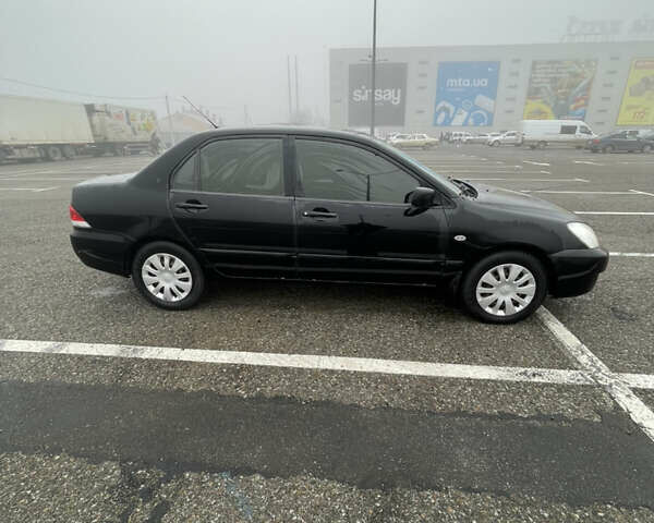Черный Мицубиси Лансер, объемом двигателя 1.58 л и пробегом 214 тыс. км за 4400 $, фото 8 на Automoto.ua