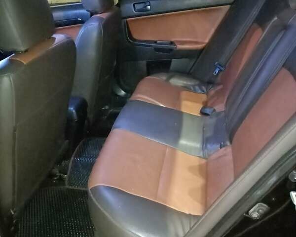 Черный Мицубиси Лансер, объемом двигателя 2 л и пробегом 240 тыс. км за 6400 $, фото 10 на Automoto.ua