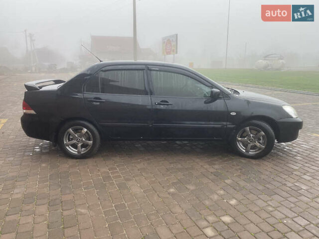 Черный Мицубиси Лансер, объемом двигателя 1.58 л и пробегом 211 тыс. км за 6333 $, фото 4 на Automoto.ua