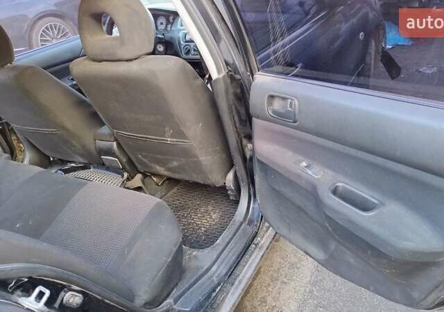 Черный Мицубиси Лансер, объемом двигателя 1.6 л и пробегом 200 тыс. км за 2000 $, фото 7 на Automoto.ua