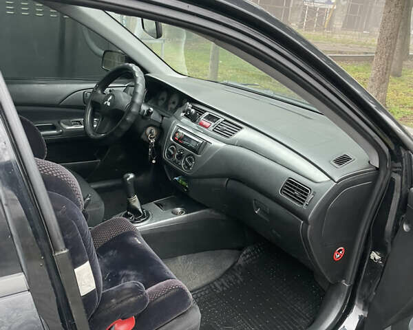 Черный Мицубиси Лансер, объемом двигателя 1.58 л и пробегом 214 тыс. км за 4400 $, фото 14 на Automoto.ua