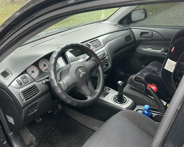 Черный Мицубиси Лансер, объемом двигателя 1.58 л и пробегом 214 тыс. км за 4400 $, фото 18 на Automoto.ua