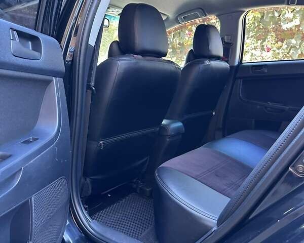 Черный Мицубиси Лансер, объемом двигателя 2 л и пробегом 230 тыс. км за 7000 $, фото 5 на Automoto.ua