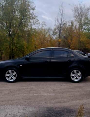 Черный Мицубиси Лансер, объемом двигателя 2 л и пробегом 211 тыс. км за 6900 $, фото 2 на Automoto.ua