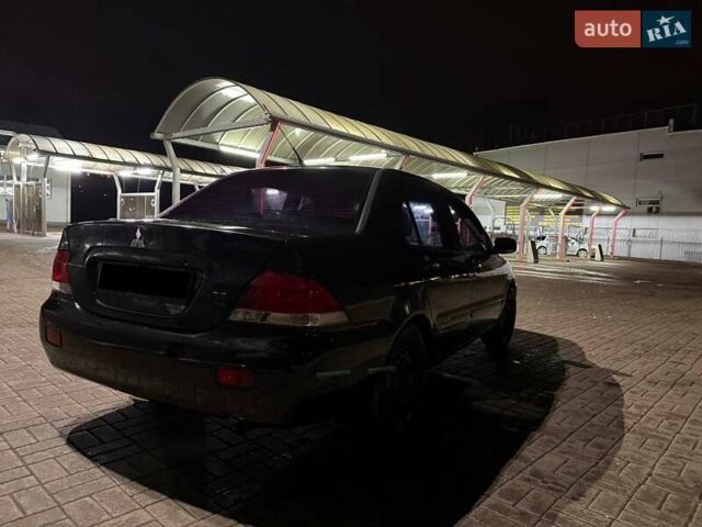 Черный Мицубиси Лансер, объемом двигателя 1.6 л и пробегом 305 тыс. км за 4200 $, фото 1 на Automoto.ua