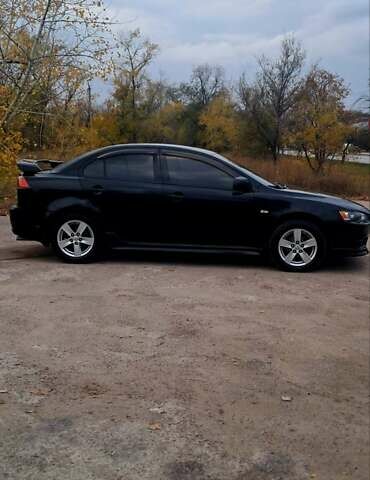 Черный Мицубиси Лансер, объемом двигателя 2 л и пробегом 211 тыс. км за 6900 $, фото 1 на Automoto.ua