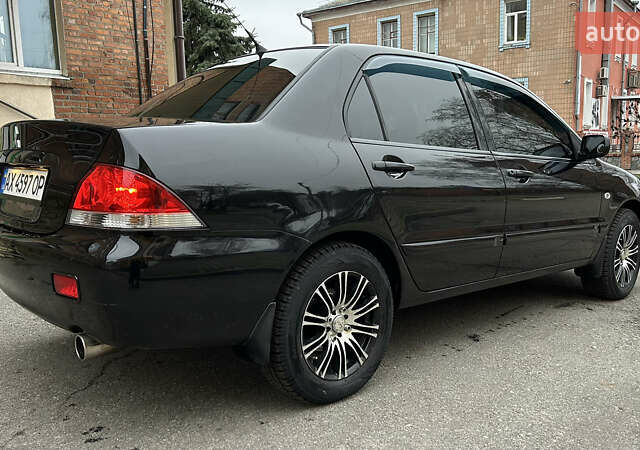 Чорний Міцубісі Lancer, об'ємом двигуна 1.58 л та пробігом 167 тис. км за 4800 $, фото 4 на Automoto.ua