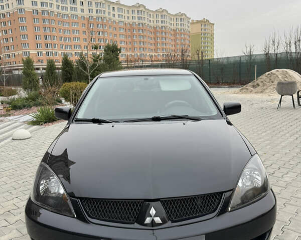 Черный Мицубиси Лансер, объемом двигателя 1.6 л и пробегом 240 тыс. км за 5200 $, фото 1 на Automoto.ua