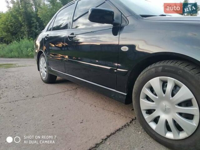 Черный Мицубиси Лансер, объемом двигателя 1.58 л и пробегом 216 тыс. км за 4950 $, фото 12 на Automoto.ua