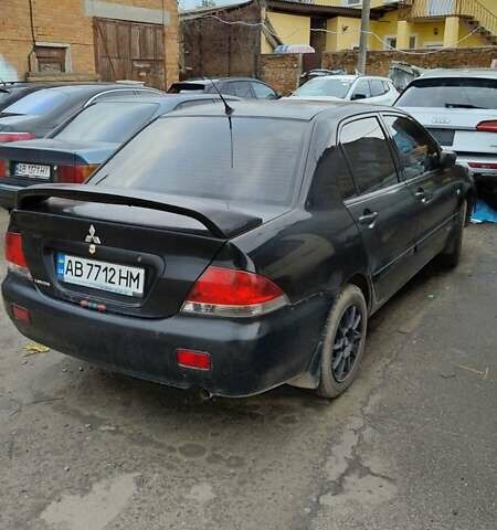 Черный Мицубиси Лансер, объемом двигателя 1.6 л и пробегом 200 тыс. км за 2000 $, фото 2 на Automoto.ua