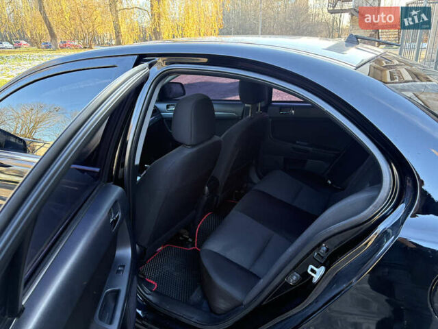 Черный Мицубиси Лансер, объемом двигателя 2 л и пробегом 236 тыс. км за 6450 $, фото 7 на Automoto.ua