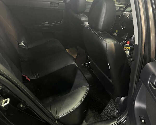 Черный Мицубиси Лансер, объемом двигателя 2 л и пробегом 200 тыс. км за 8000 $, фото 18 на Automoto.ua