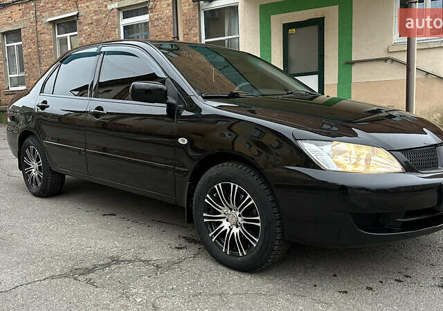 Чорний Міцубісі Lancer, об'ємом двигуна 1.58 л та пробігом 167 тис. км за 4800 $, фото 6 на Automoto.ua