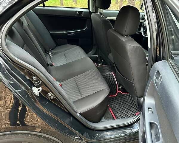 Черный Мицубиси Лансер, объемом двигателя 2 л и пробегом 216 тыс. км за 5600 $, фото 9 на Automoto.ua