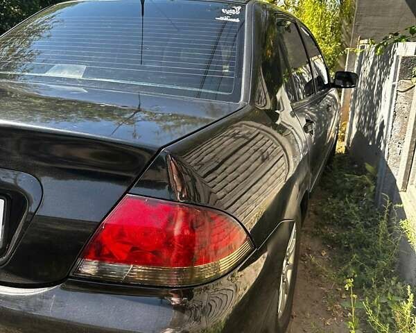 Чорний Міцубісі Lancer, об'ємом двигуна 1.6 л та пробігом 294 тис. км за 6500 $, фото 6 на Automoto.ua