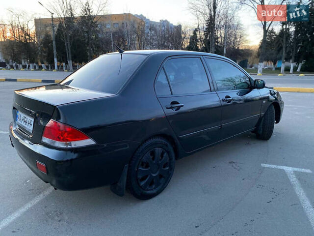 Чорний Міцубісі Lancer, об'ємом двигуна 1.58 л та пробігом 327 тис. км за 4000 $, фото 7 на Automoto.ua
