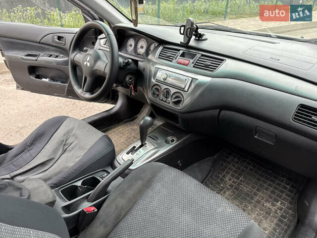 Чорний Міцубісі Lancer, об'ємом двигуна 1.58 л та пробігом 388 тис. км за 2300 $, фото 10 на Automoto.ua