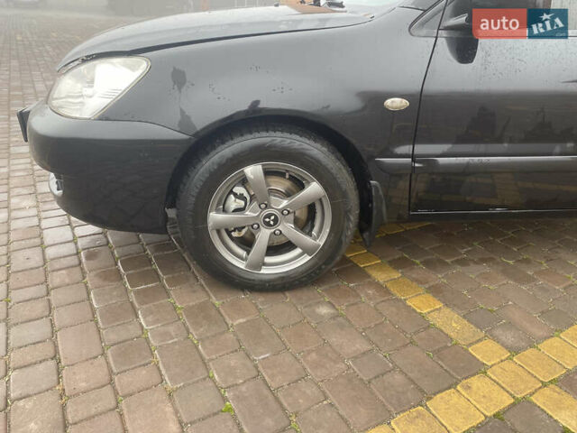 Черный Мицубиси Лансер, объемом двигателя 1.58 л и пробегом 211 тыс. км за 6333 $, фото 26 на Automoto.ua