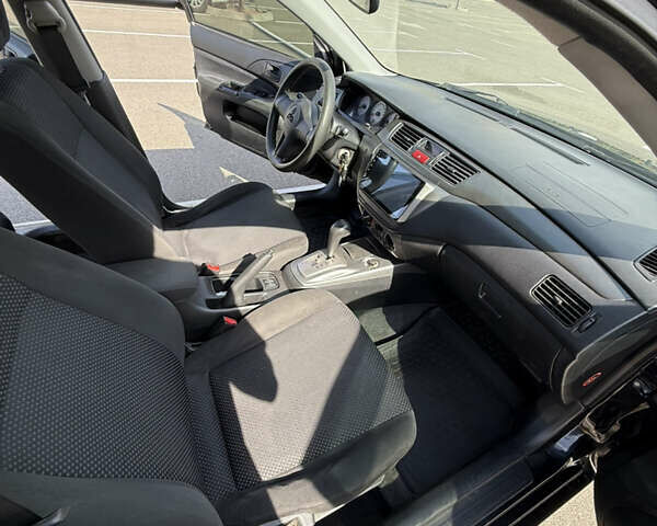 Черный Мицубиси Лансер, объемом двигателя 1.6 л и пробегом 321 тыс. км за 5000 $, фото 25 на Automoto.ua