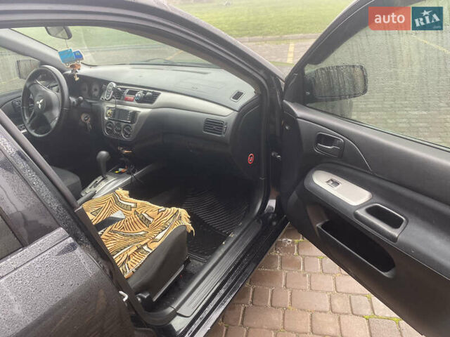 Черный Мицубиси Лансер, объемом двигателя 1.58 л и пробегом 211 тыс. км за 6333 $, фото 38 на Automoto.ua