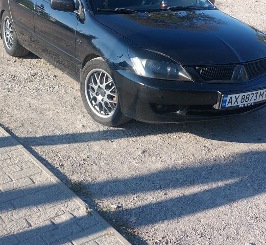 Черный Мицубиси Лансер, объемом двигателя 1.6 л и пробегом 340 тыс. км за 4500 $, фото 1 на Automoto.ua