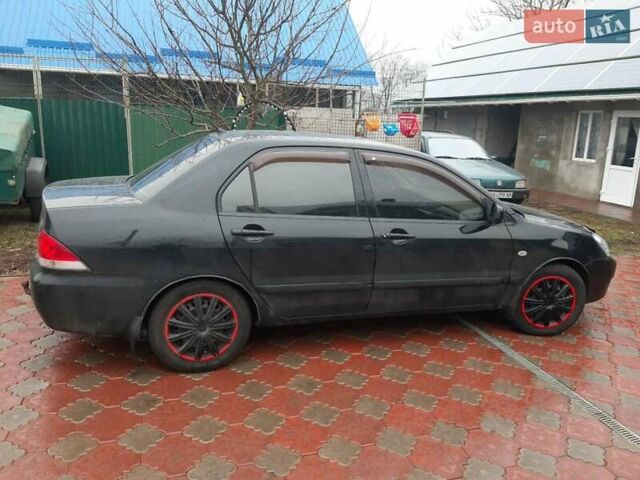 Черный Мицубиси Лансер, объемом двигателя 1.6 л и пробегом 256 тыс. км за 6300 $, фото 2 на Automoto.ua