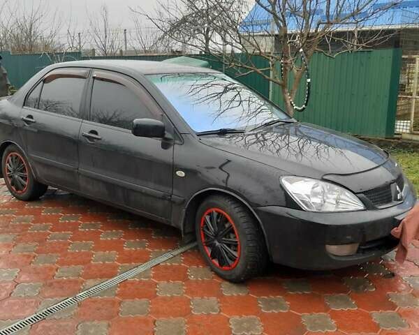 Черный Мицубиси Лансер, объемом двигателя 1.6 л и пробегом 256 тыс. км за 6300 $, фото 1 на Automoto.ua