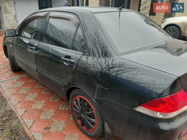 Черный Мицубиси Лансер, объемом двигателя 1.6 л и пробегом 256 тыс. км за 6300 $, фото 3 на Automoto.ua