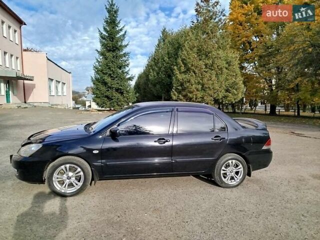 Черный Мицубиси Лансер, объемом двигателя 1.58 л и пробегом 78 тыс. км за 6500 $, фото 1 на Automoto.ua