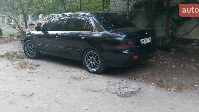 Чорний Міцубісі Lancer, об'ємом двигуна 1.58 л та пробігом 345 тис. км за 4500 $, фото 1 на Automoto.ua