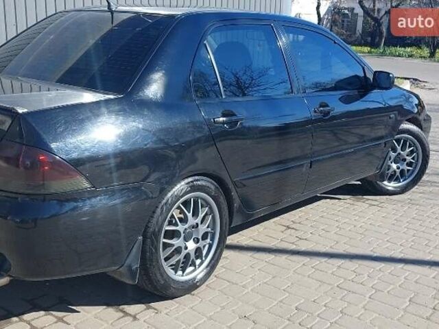 Чорний Міцубісі Lancer, об'ємом двигуна 1.58 л та пробігом 345 тис. км за 4500 $, фото 4 на Automoto.ua