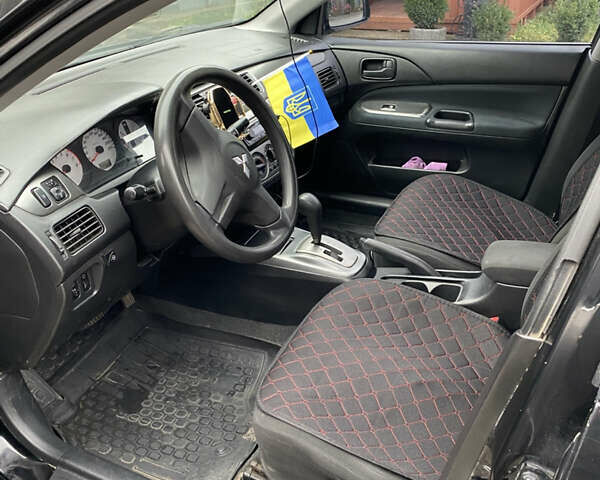 Чорний Міцубісі Lancer, об'ємом двигуна 1.58 л та пробігом 287 тис. км за 4750 $, фото 8 на Automoto.ua