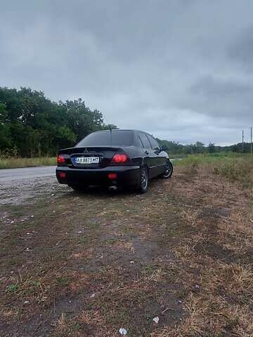 Чорний Міцубісі Lancer, об'ємом двигуна 1.58 л та пробігом 345 тис. км за 4500 $, фото 6 на Automoto.ua