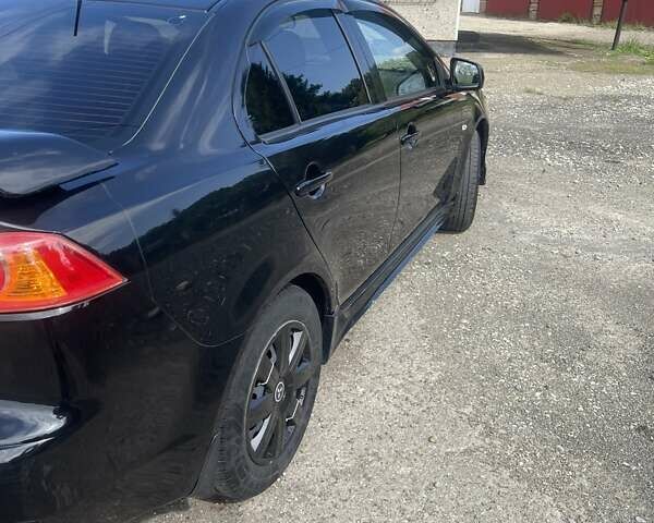 Черный Мицубиси Лансер, объемом двигателя 2 л и пробегом 201 тыс. км за 7000 $, фото 1 на Automoto.ua